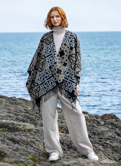 Red head model standing in front of water in black celtic knot shawl